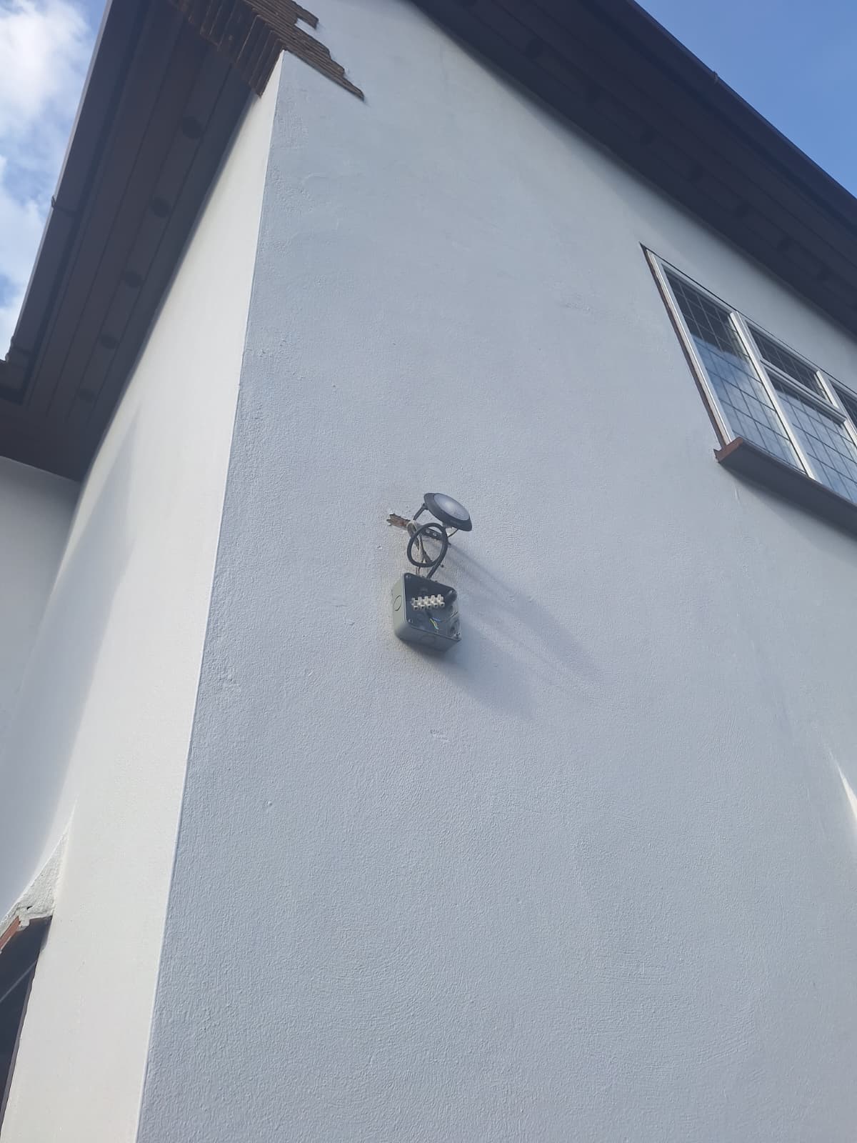 Outdoor wall light fitted on a rendered house wall